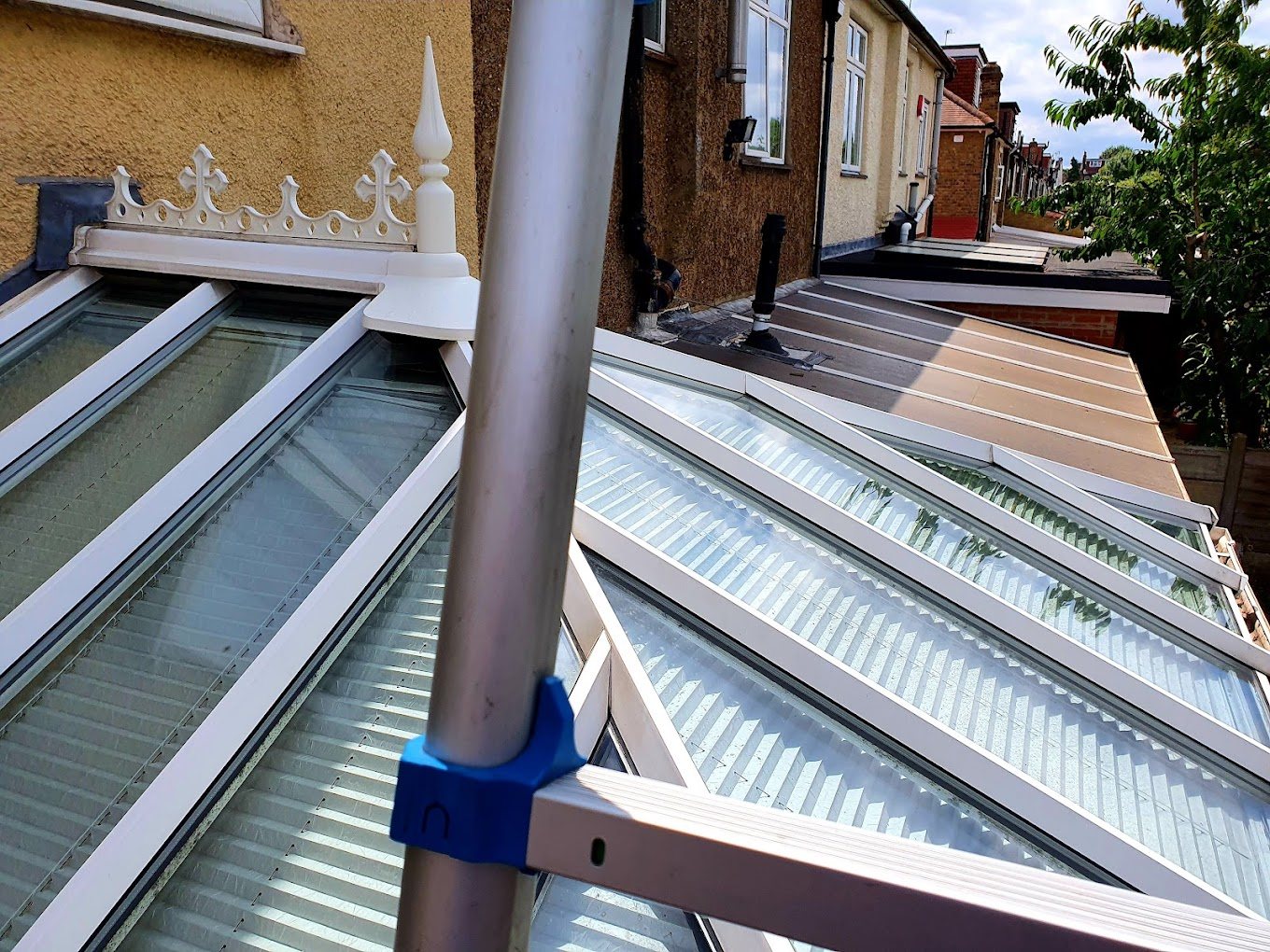 Ladder on a conservatory roof during a clean.